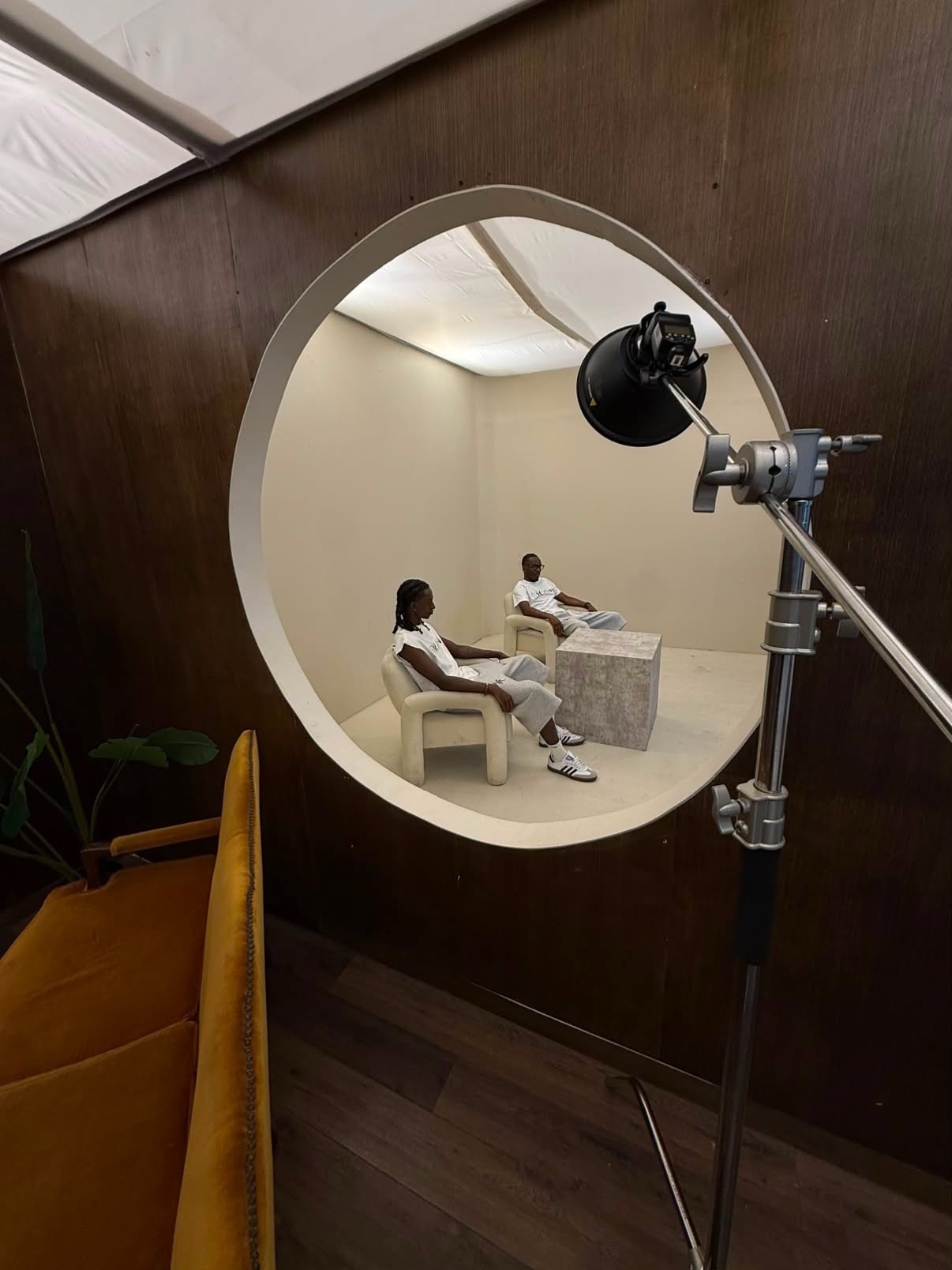 View through a circular porthole into the bone set, light stand in frame